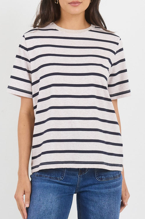 Woman wearing a striped shirt and blue jeans on a white background