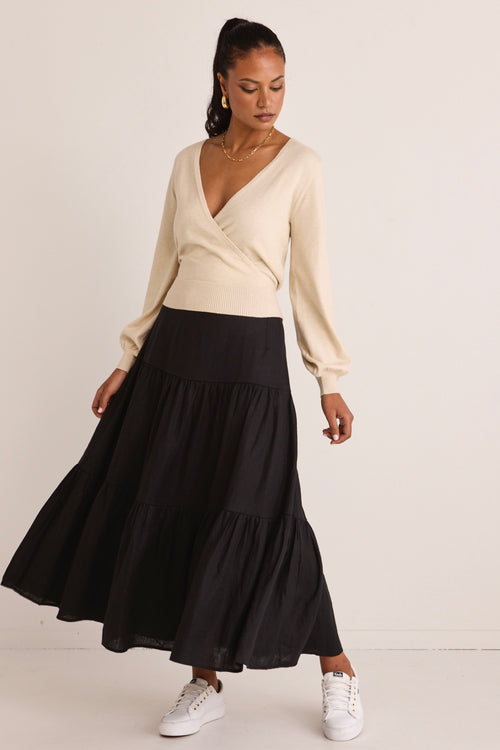 model wears a black linen midi skirt