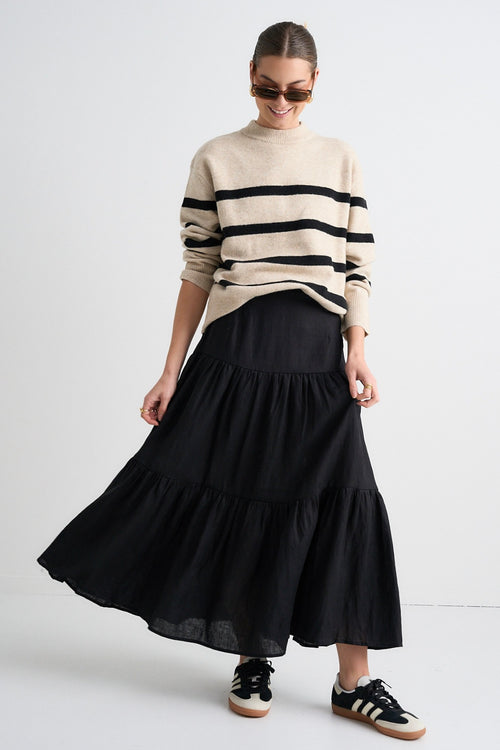 model wears a beige stripe knit model wears a beige stripe knit and a black linen skirt