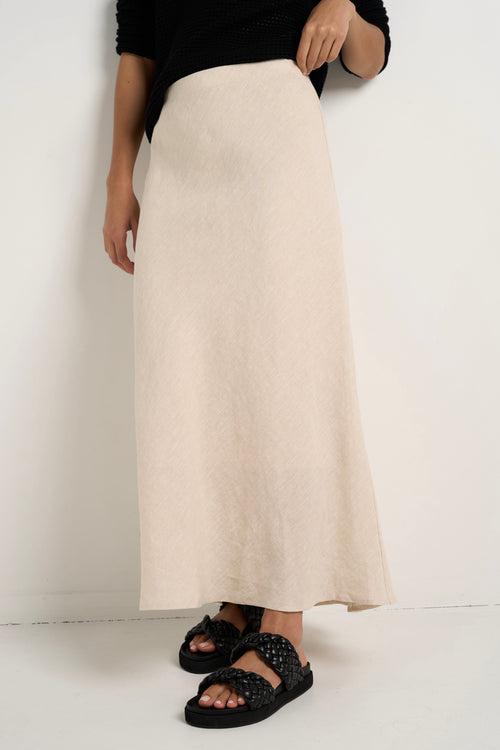 model wears a natural linen midi skirt