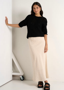 model wears a natural linen midi skirt