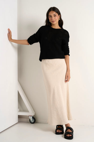 model wears a natural linen midi skirt