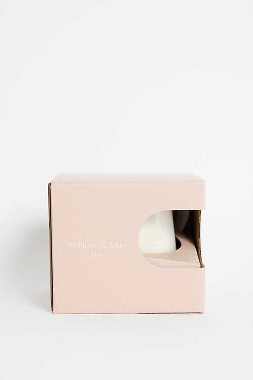 Cream-coloured ceramic mug with the word ‘Bliss’ embossed on the front, photographed on a white background