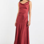 Woman wearing a burgundy evening gown on a white background
