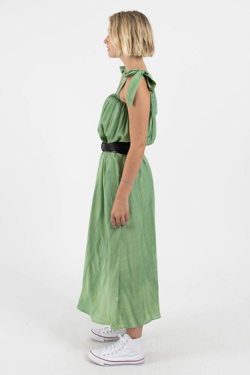 model wears green midi dress