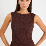 Woman wears a brown lace top