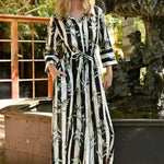 Woman wearing a black white stripe with olive branches