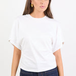 Woman wearing a white t-shirt and dark blue jeans on a white background