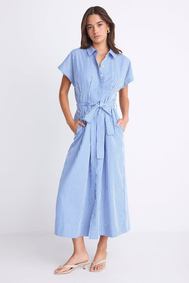 Woman wearing a bright blue striped midi shirt dress with short sleeves, button front, waist tie, and pleated skirt.