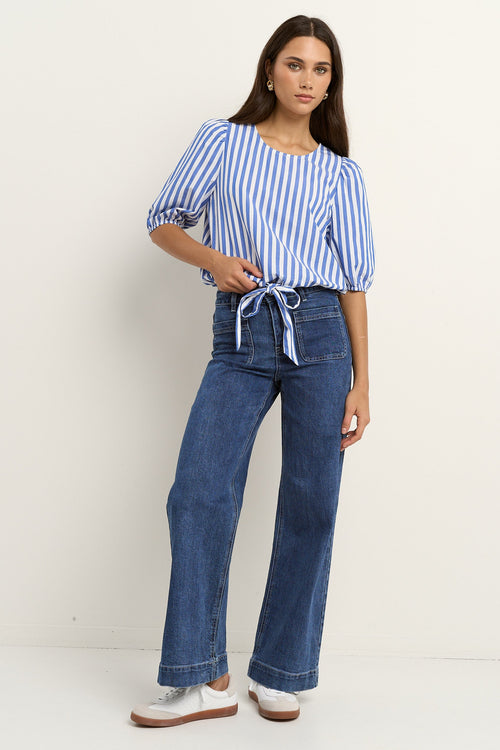 woman wearing a blue white stripe top and blue jeans