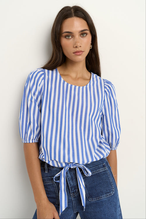 woman wearing a blue white stripe top and blue jeans