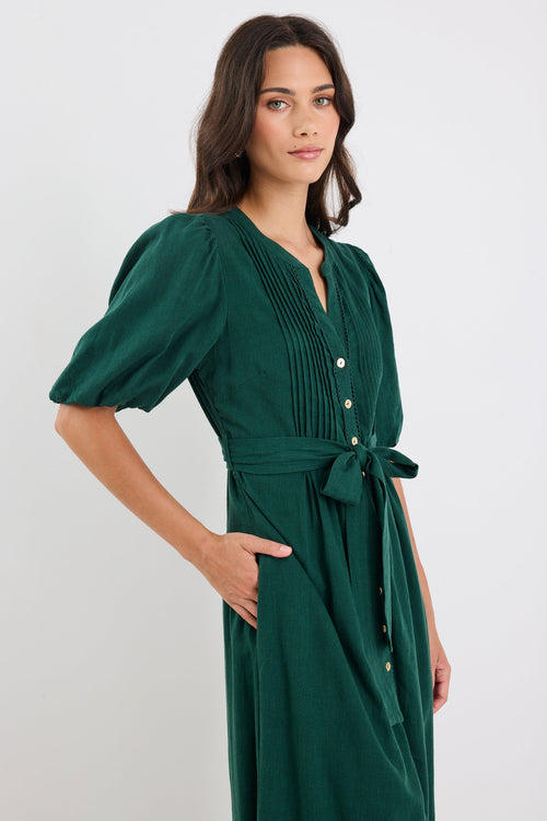 Woman wearing a green dress with a white background