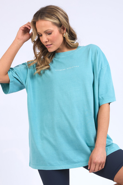 model wears oversized blue shirt