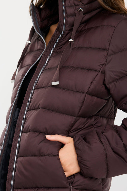 Brown puffer jacket worn by a person on a white background