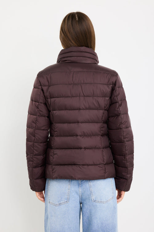 Person wearing a brown puffer jacket on a white background