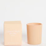 Beige candle and box on a white background