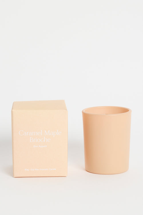 Beige candle and box on a white background