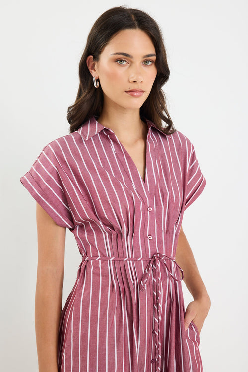Woman wearing a striped dress against a white background