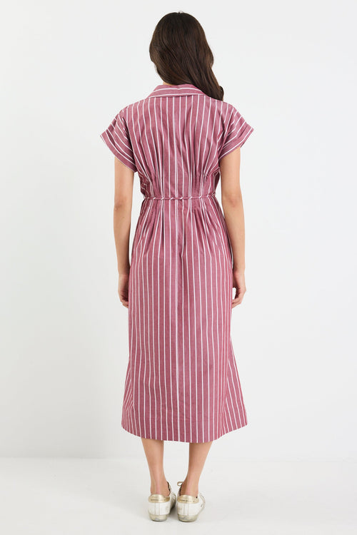 Woman wearing a pink and white striped dress on a white background