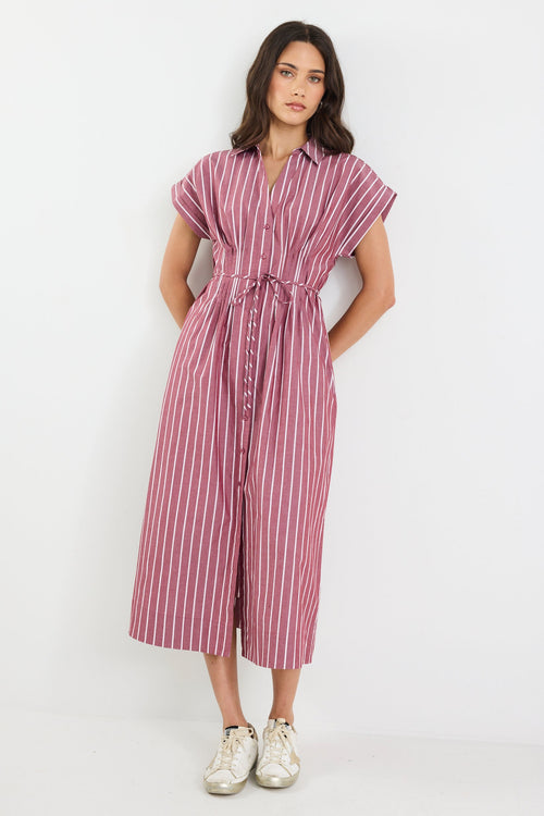Woman wearing a striped dress on a white background