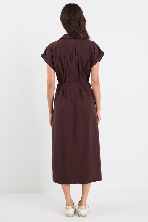 Woman wearing a brown dress on a white background