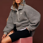 model wears a grey jumper