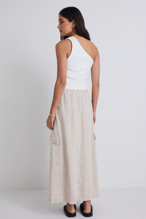 model wears natural linen maxi skirt and white one shoulder top