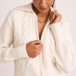 model wears a white knit zip jumper