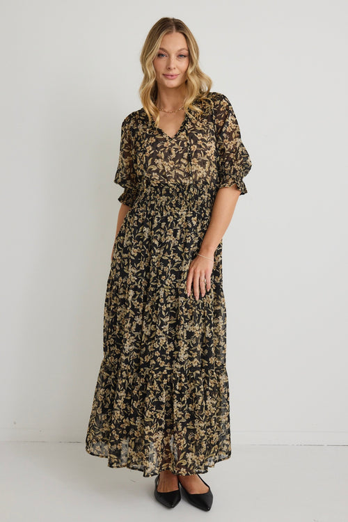 model wears a Black Gold Floral Midi Dress