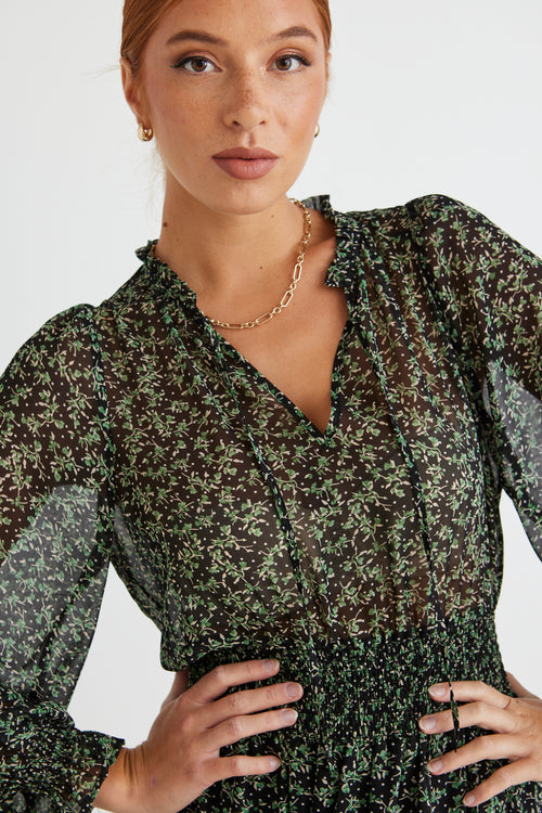 model wears a green floral maxi dress