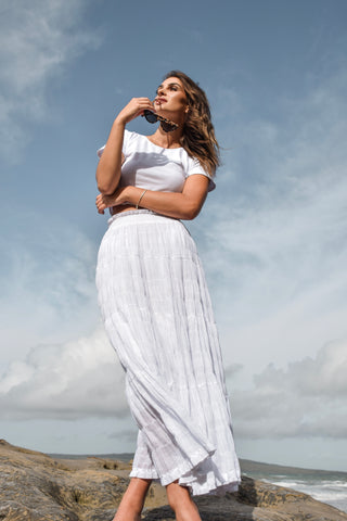 model wears a white maxi skirt