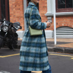 model wears a blue check coat