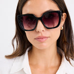 model wears black sunglasses