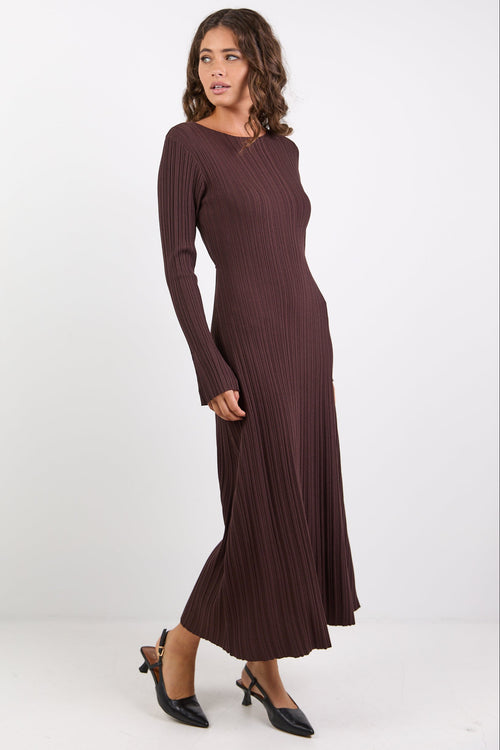Woman wearing a long brown dress on a white background