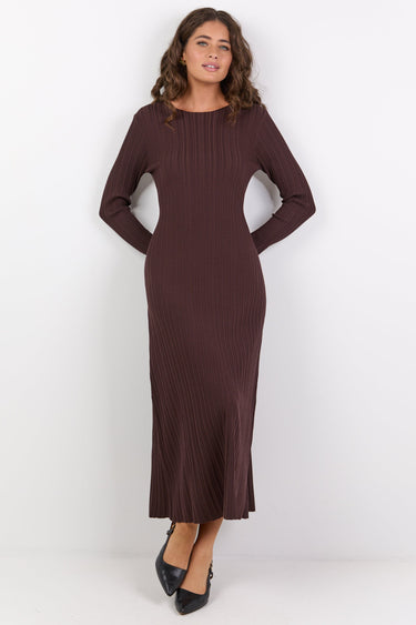 Woman wearing a brown dress against a white background