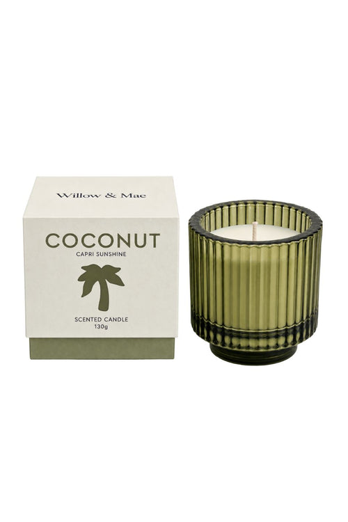A coconut-scented scented candle by Willow & Mae in a ribbed olive green glass jar, shown next to its white packaging box with a green palm tree logo.