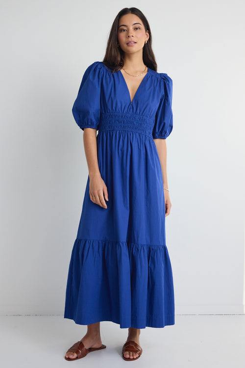 model wears a blue maxi dress