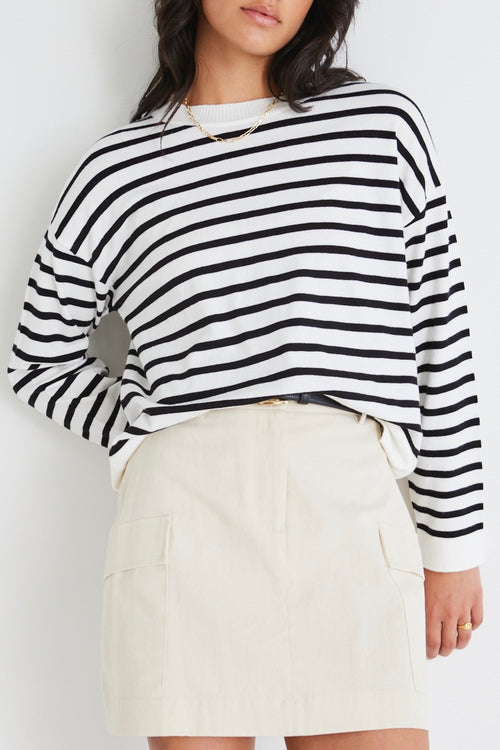 model wears a white stripe knit
