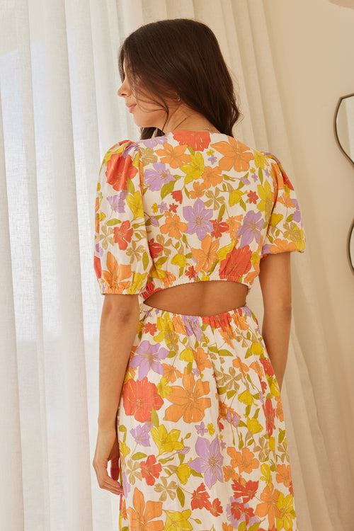 model in long orange red yellow and purple floral dress