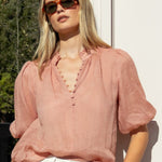 model wearing blush blouse and white top 