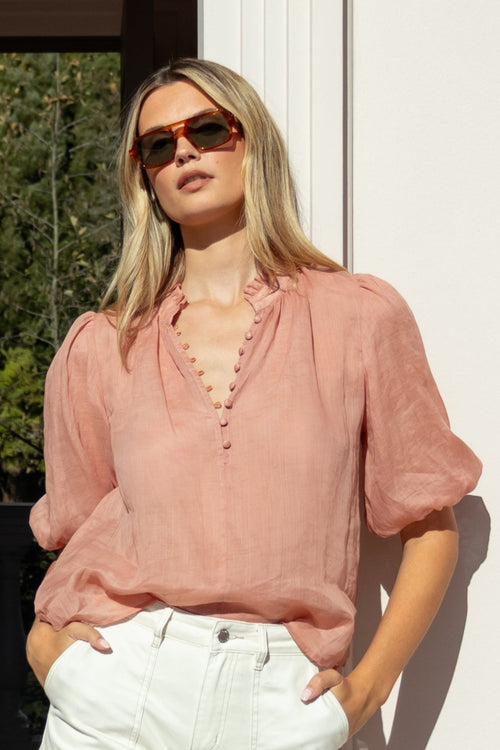 model wearing blush blouse and white top 