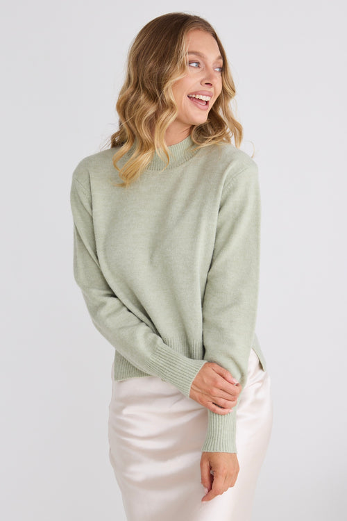 model wears a green knit