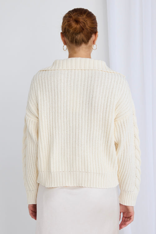 model wears a white knit jumper