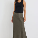 Woman wearing a khaki linen midi skirt and black tank
