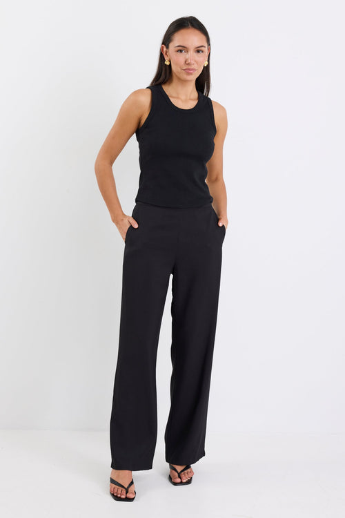 woman wearing black pant and black tank