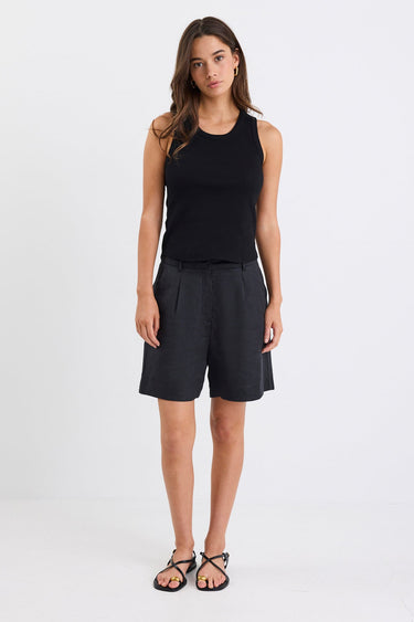 Woman wearing black linen. shorts and black tank
