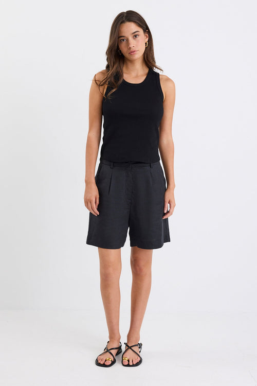 Woman wearing black linen. shorts and black tank