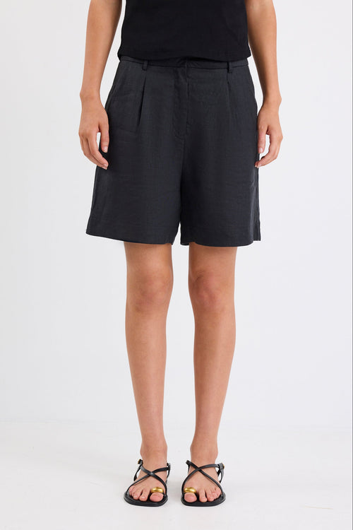 Woman wearing black linen. shorts and black tank