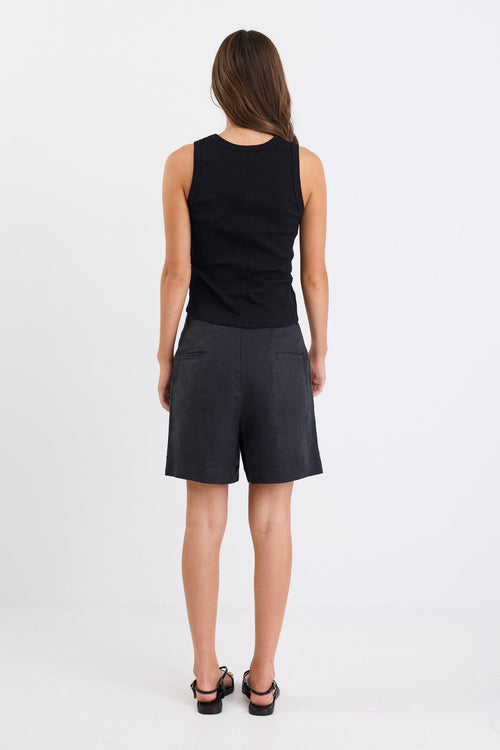 Woman wearing black linen. shorts and black tank