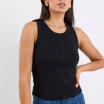 woman wearing black rib tank and blue jeans
